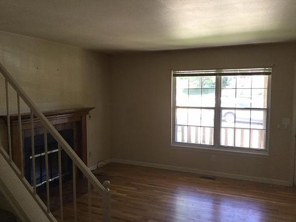 Living Room with wood burning fireplace and hardwood floorin