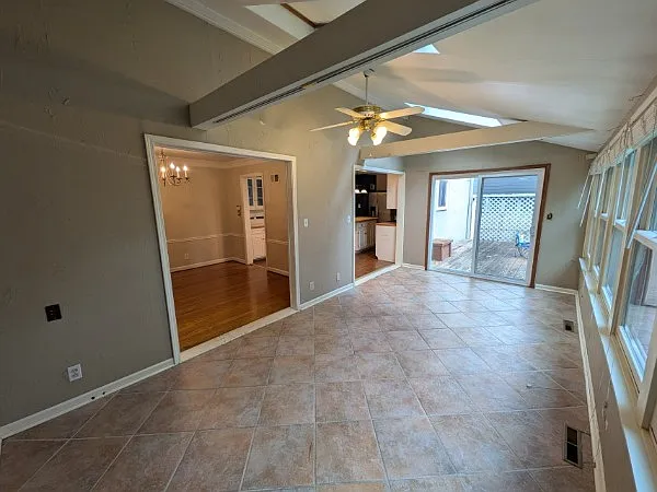 Sunroom/Family room walks out to Deck + connects to Dining Room and Kitchen.