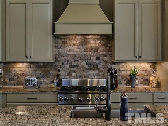 Directly adjacent to the kitchen, the keeping room has relaxing views, tasteful stained bead board c