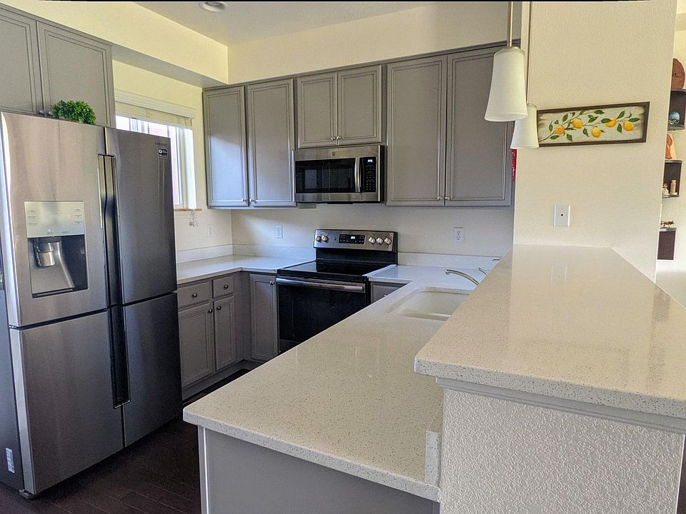 Kitchen with upgraded stainless steel appliances and quartz countertop.