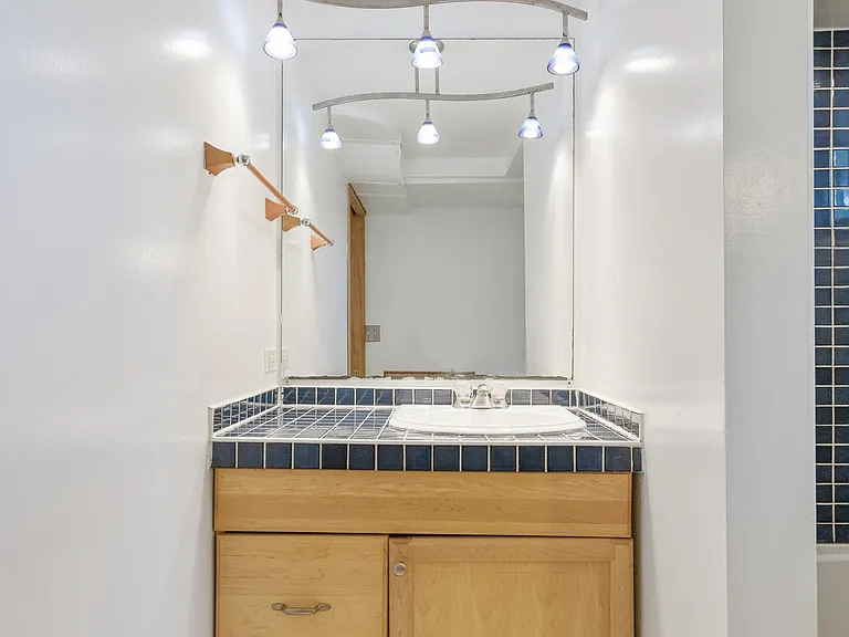 Bathroom Vanity with Italian blue ceramic tile, maple cabinets and very cool lighting!