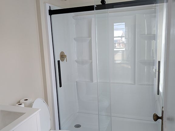 Brand new shower, toilet and sink vanity.