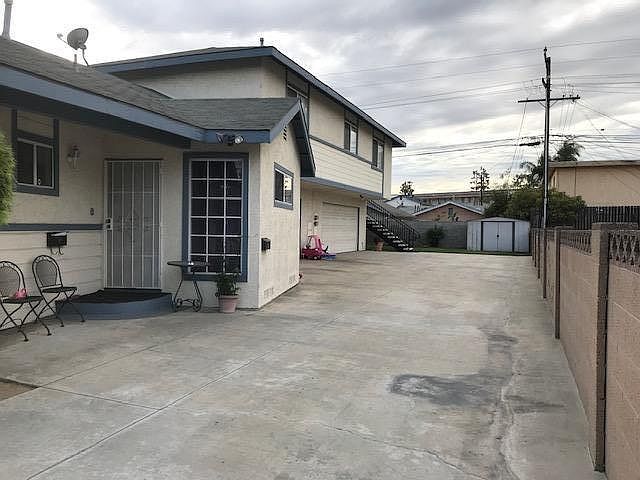 Duplex entrance with 2 car garage and 1 driveway parking place.