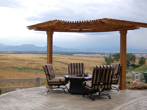 Back pergola off stamped colored concrete patio