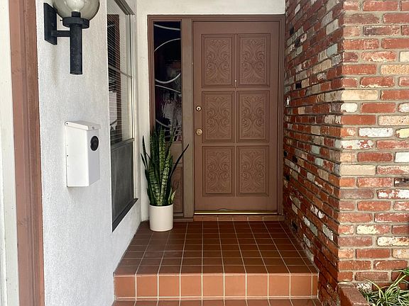 Private covered entry, custom stained glass sidelite, original MCM smoke glass dome light fixtures