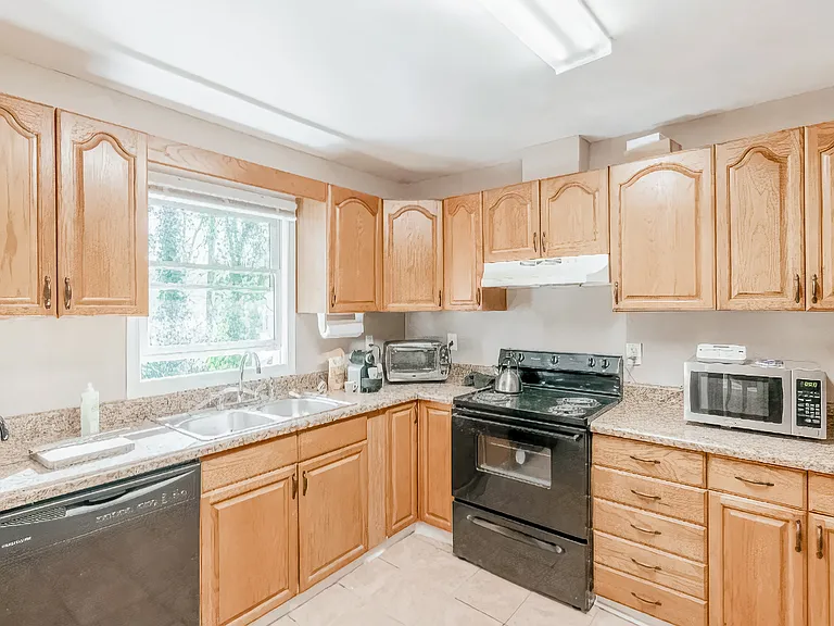 Kitchen with new smooth top range and 2 refrigerators