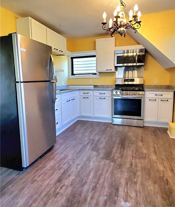 Kitchen: new cabinets, granite countertop. Refrigerator, stove and microwave.