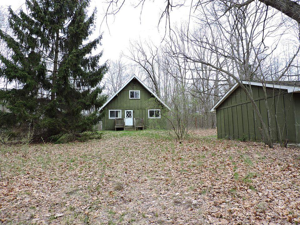 FEELING HANDY?  This house has great bones and a walk out basement that would add an additional 918 square feet of finishable space to this almost 1400 sq ft home with 3 bedrooms, including a main floor master, and set up for 1.5 baths.  The main floor is open kitchen, dining room, and living room, overlooking 10.08 wooded acreage.  There is room for an outbuilding, or for hunting out your backdoor.  There are 3 lots that make up the 10 acres, with the house sitting on the middle lot which is 3.36 acres.  Keep all 10 acres, or sell off one or both of the other lots.  Home has newer furnace and roof.  Much work is needed, however, therefore cash offers only can be accepted.  