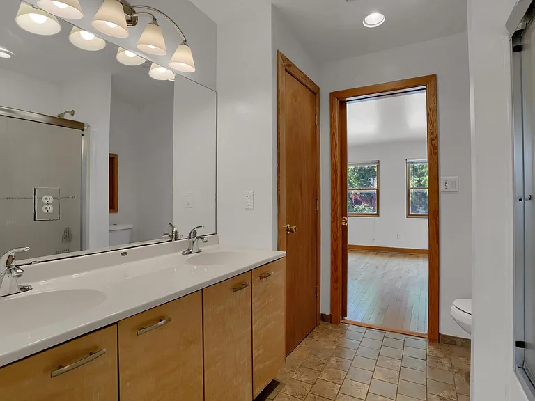 Bathroom Upper Level - double sink vanity, linen closet, shower/tub, marbled tile floor
