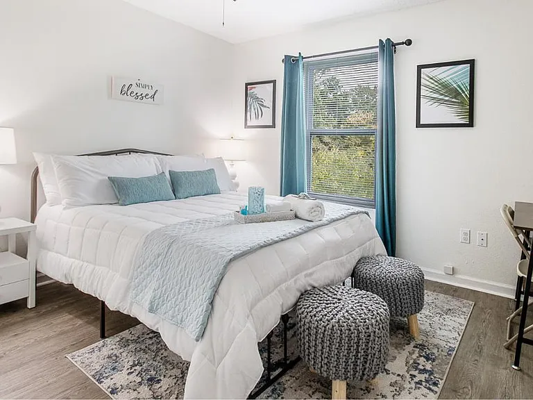 Experience nature. This bedroom offers a peaceful haven where guests can unwind, connect with nature, and revel in the beauty of the beachfront surroundings.