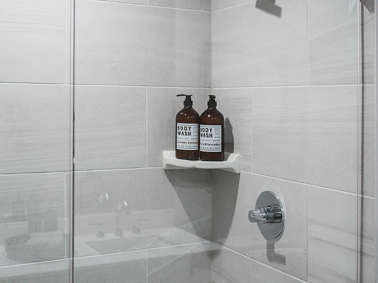 Modern bathrooms featuring tiled showers.