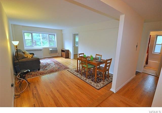 Large Living room with dining area has hardwood floors and quiet views.