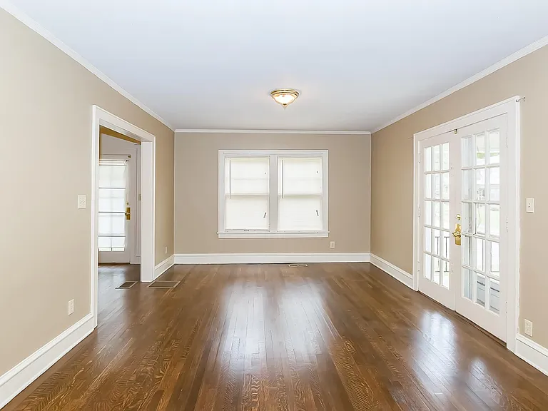 The Large Living room has Refinished Hardwood Floors . The Side porch awaits you through the French doors.