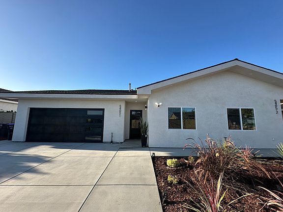 Brand new modern home with sleek design, large windows, fresh paint, stylish entryway, and clean landscaping. Spacious driveway and contemporary finishes offer standout curb appeal in a prime Santa Ana location.