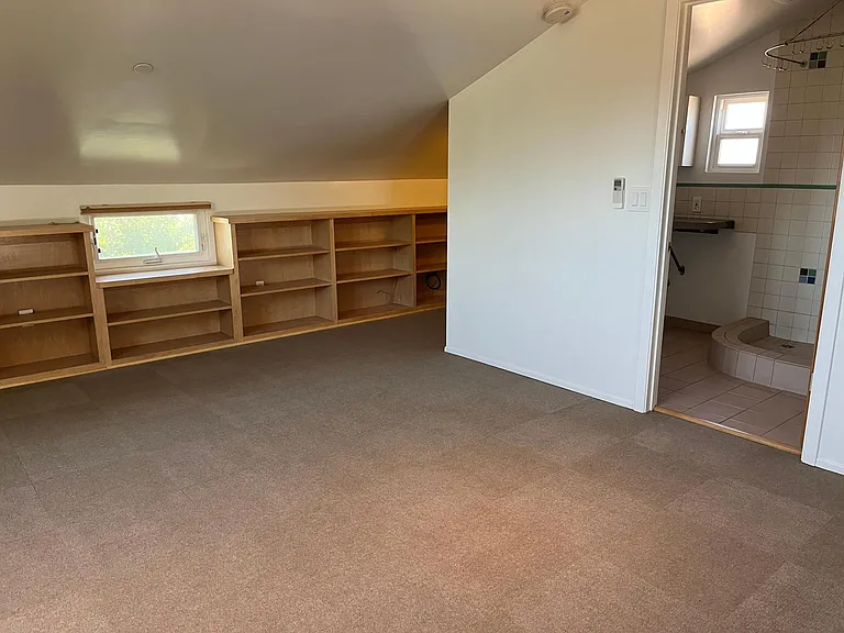Mezzanine with built-in bookcases and bathroom