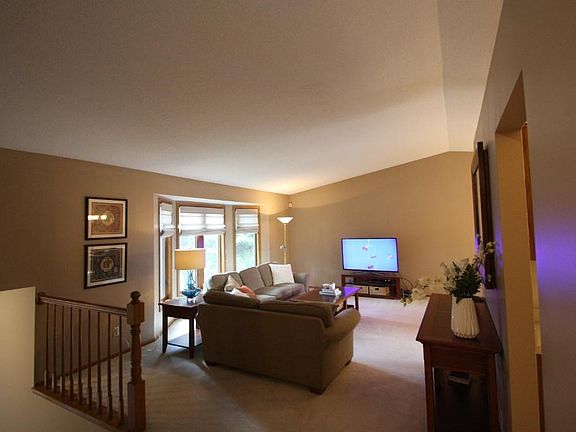 Bay windows in the living room gather morning sunlight.