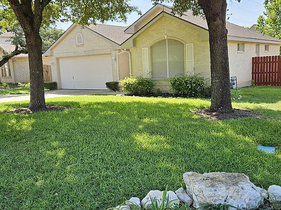 Front with large oaks.