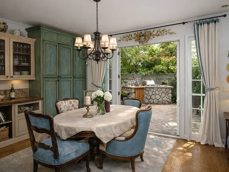 Elegant dining area with built-in cabinetry and direct access to private patio, perfect for indoor-outdoor living