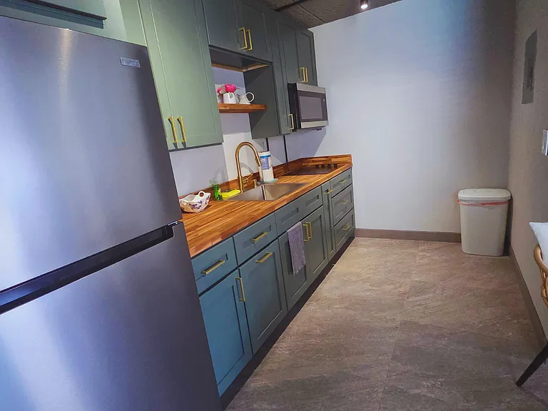 Modern kitchen with elegant colors and plenty of cabinet space.