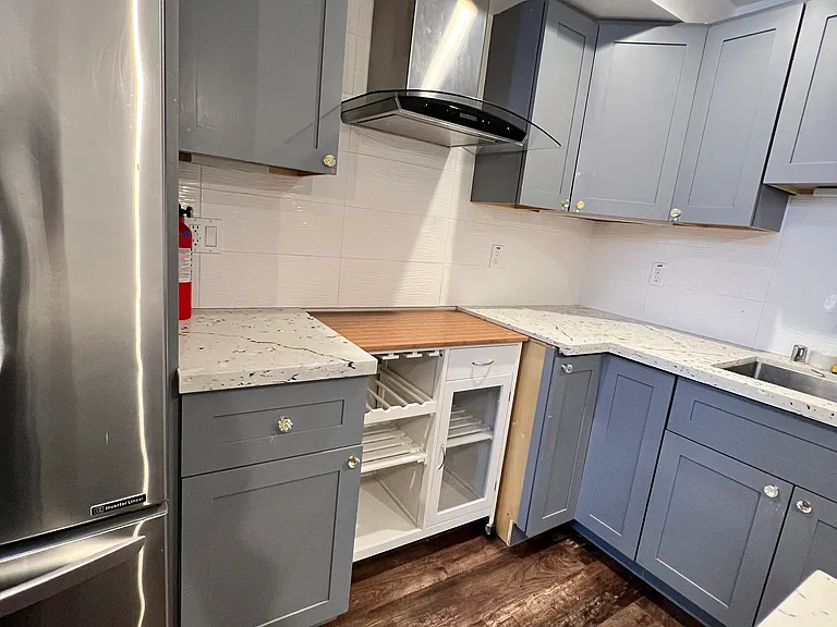 No stove/oven. Large fridge, sink and dishwasher included with overhead fan.