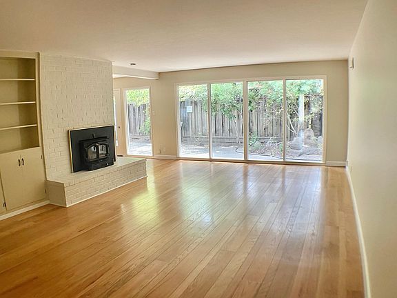 Large living room w/ built in shelving. 
So much natural light!
