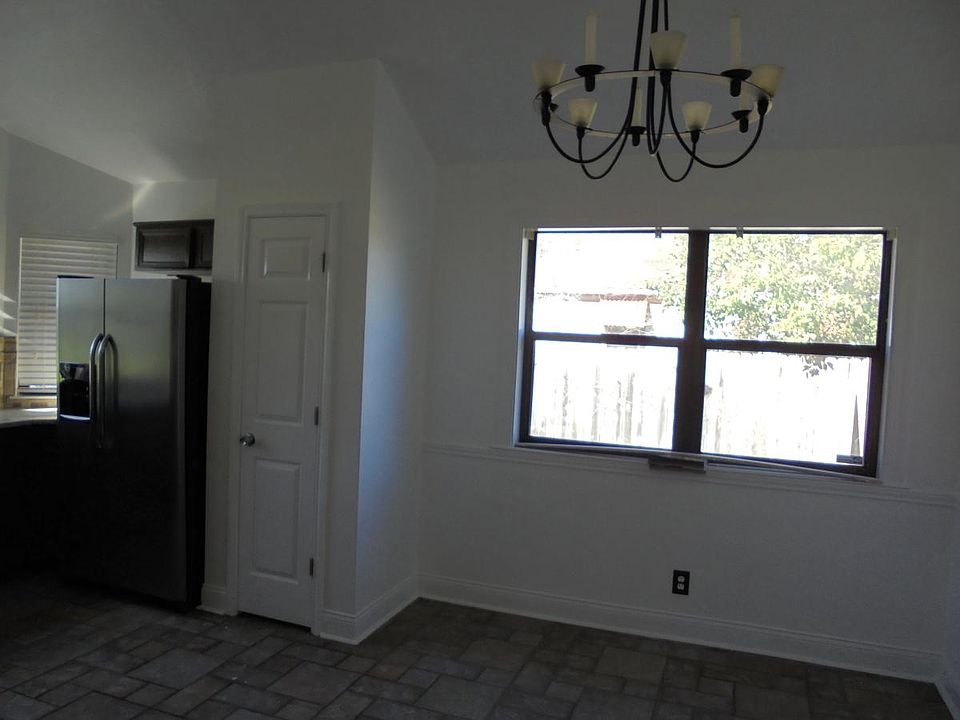 Dining area next to kitchen and a new stainless steel refrig