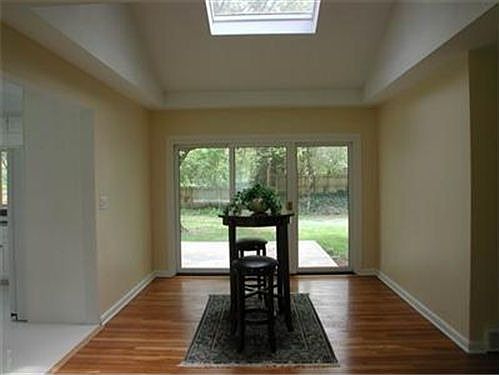 The dining room with its' hardwood floor, cathedral ceiling, and skylight!
