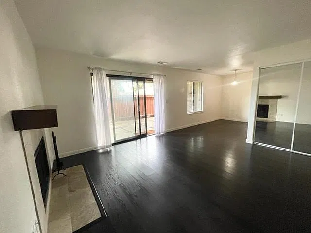 Living area and sliding door to patio, mirrored closet