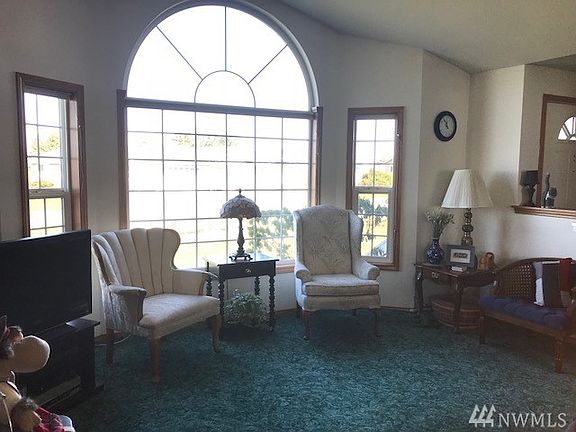 Living room has bay window with views toward Dungeness Bay.