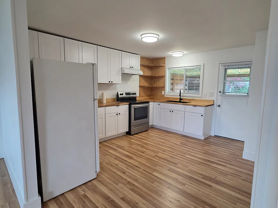 Remodeled kitchen with new countertops, cabinets, and sink