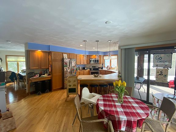 Kitchen, Dining room in distance and eating area with view to screened in porch.