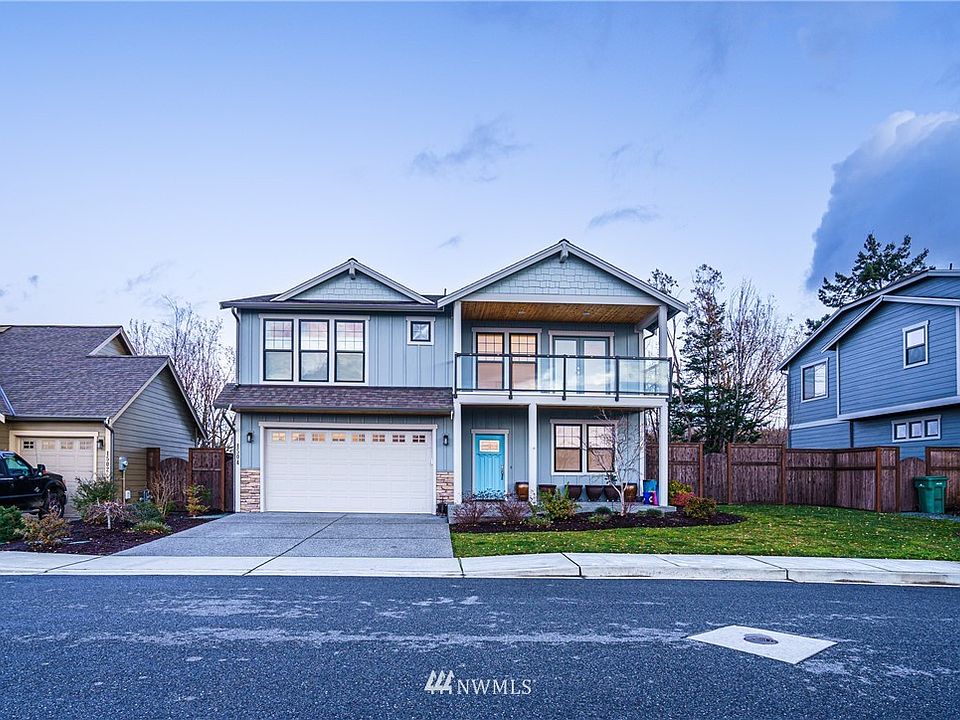 Cement siding, 2 car garage, 2 steps up to covered porch, Access backyard from both sides of home