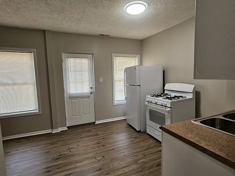 The kitchen has a new gas stove and refrigerator.