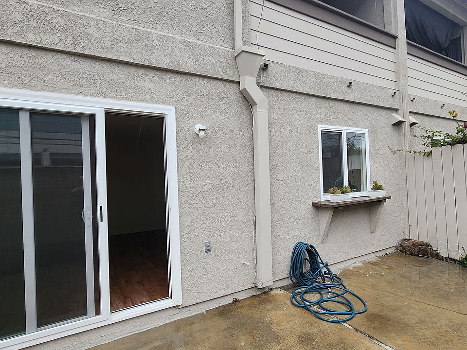 Enjoy a private backyard with a fully enclosed patio and a newer sliding glass door that brings in great natural light and easy indoor-outdoor access.