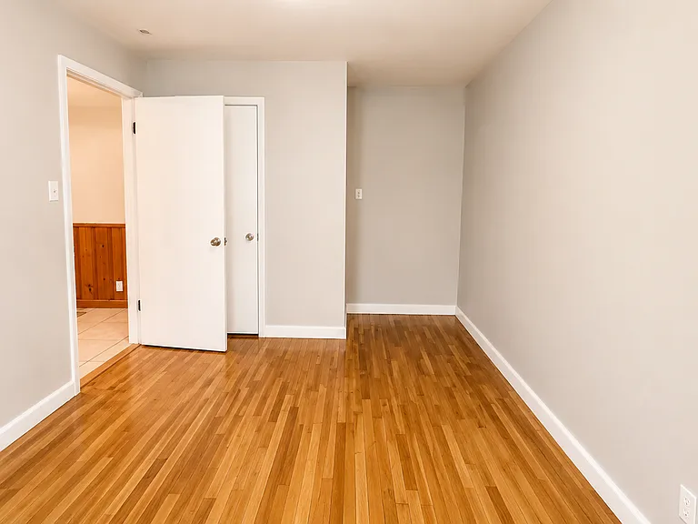 Minimalist room with warm wood floors