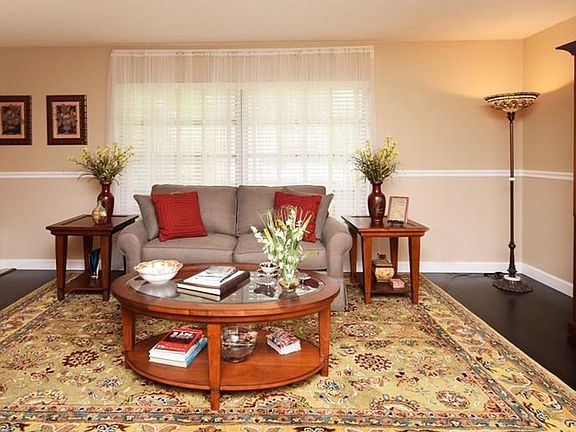 Living Room has dark bamboo floor, large bright windows.