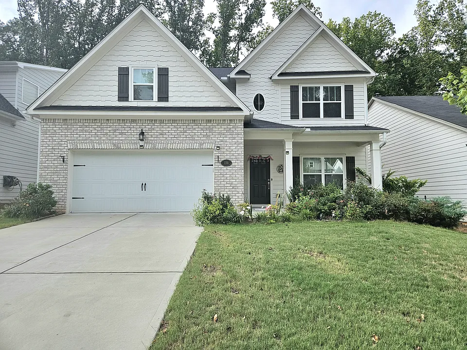 Front yard, driveway, two car garage