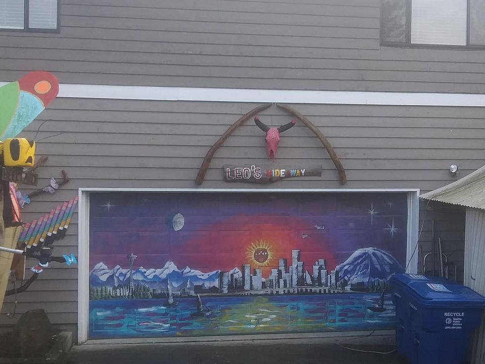 Carriage house resides above the garage. Beautiful yard art adorns the property