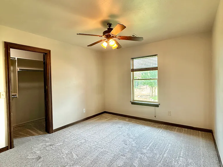 The fourth bedroom is adorned with another large walk-in closet. This house has great storage amenities and beautiful backyard views.