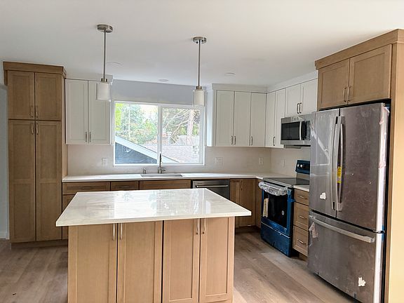 Open-concept kitchen with brand new appliances