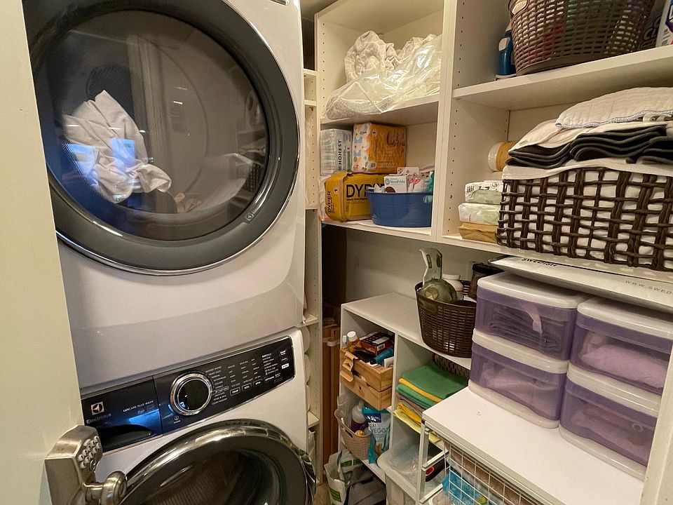 Dedicated laundry room with front load washer/dryer stack