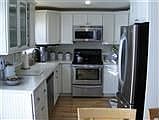 New maple cabinets / Corian counter tops and entire back wall