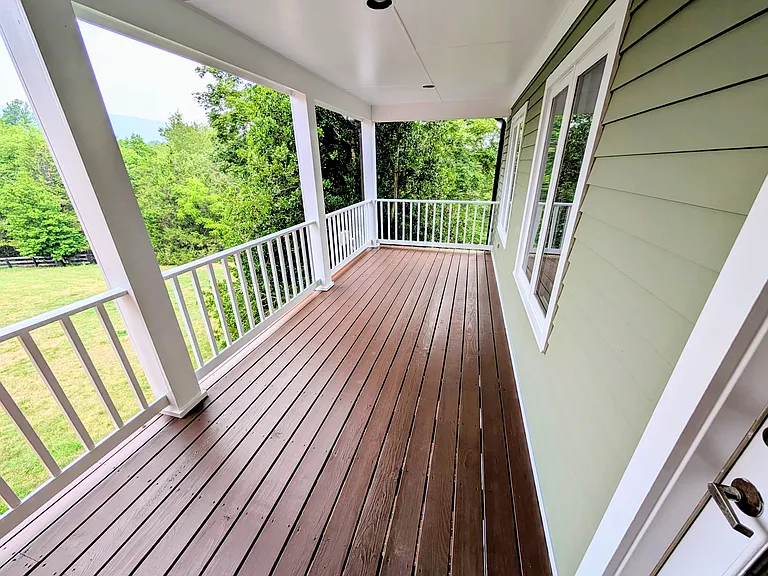 This is the upstairs porch, accessible from the master bedroom. It was redecked and stained this summer.