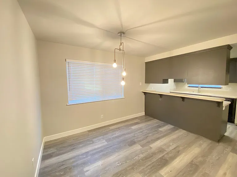 Dining area with new chandelier matching living room lighting.