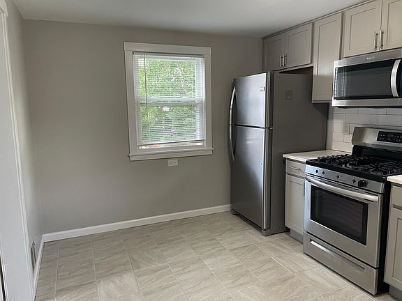 Kitchen with fridge, stove and microwave