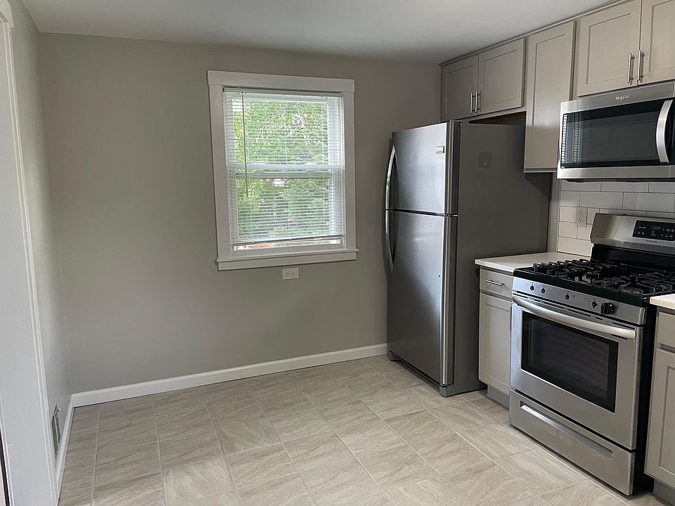 Kitchen with fridge, stove and microwave