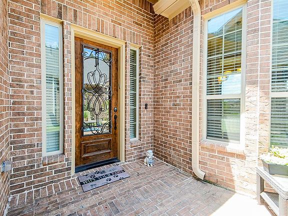 Handsome solid wood door with metal scroll details.