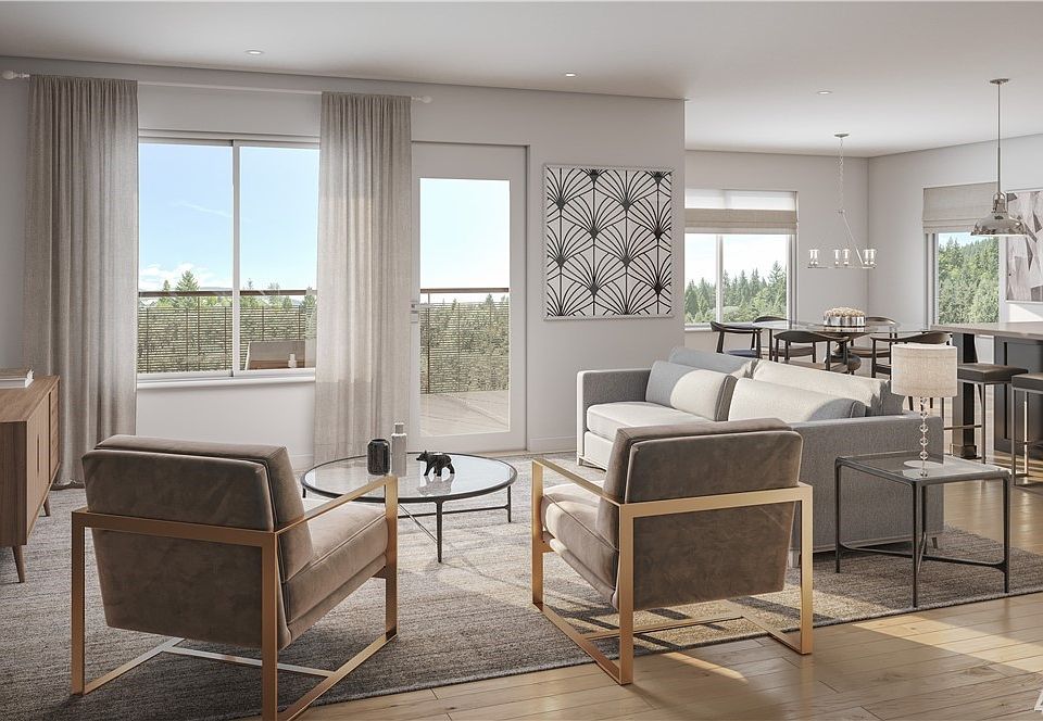 Spacious Great Room with adjoining kitchen and dining area. Photo not of actual home and may show some personalized features.