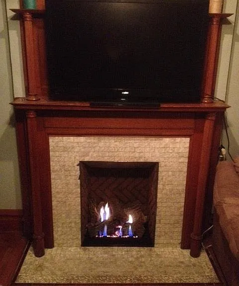 Ventless fireplace in bedroom with original mantle
