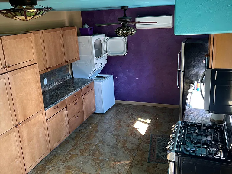 downstairs kitchen with refrigerator, stacked washer/dryer 
dbl gas stove with convection oven and microwave,Dining area in downstairs.